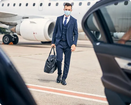 A client's point of view from inside of the car with a chauffeur serving the clients at the logan airport