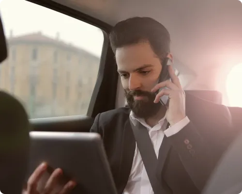 A business executive is commuting from New York to Stamford in a limo while having a business call