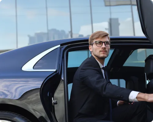 A business traveler is getting out of the car after reaching Manhattan on time