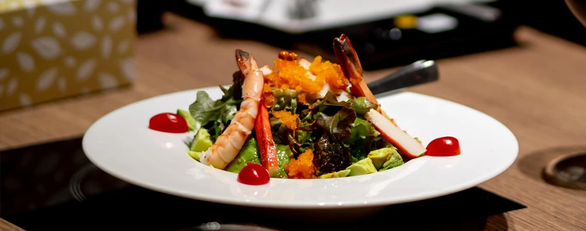 Fresh salad with shrimp at WP24 Dinner and Blind Pig, ideal snack spots near Metro-North White Plains station.