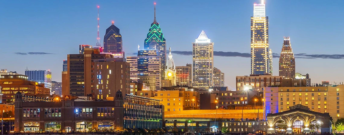 Philadelphia to Newark Airport Car Service Top Attractions card showing the Philadelphia skyline at dusk with recommendations for Reading Terminal Market, Longwood Gardens, the Liberty Bell, and Independence Hall.