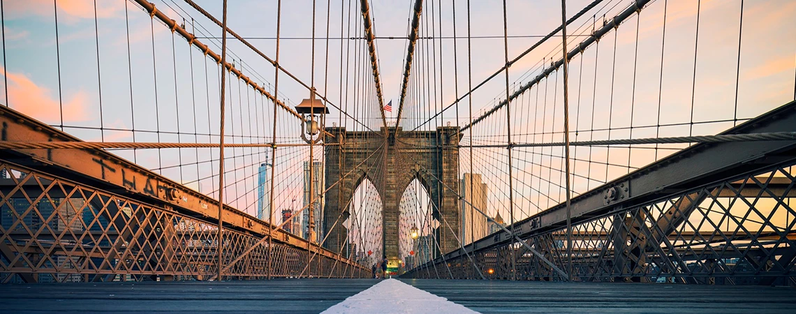 Top Attractions in Brooklyn featuring the iconic Brooklyn Bridge, with a view of the bridge's structure and city skyline, ideal for car service Brooklyn exploration.