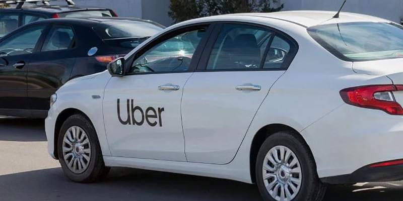 A white Uber on the road